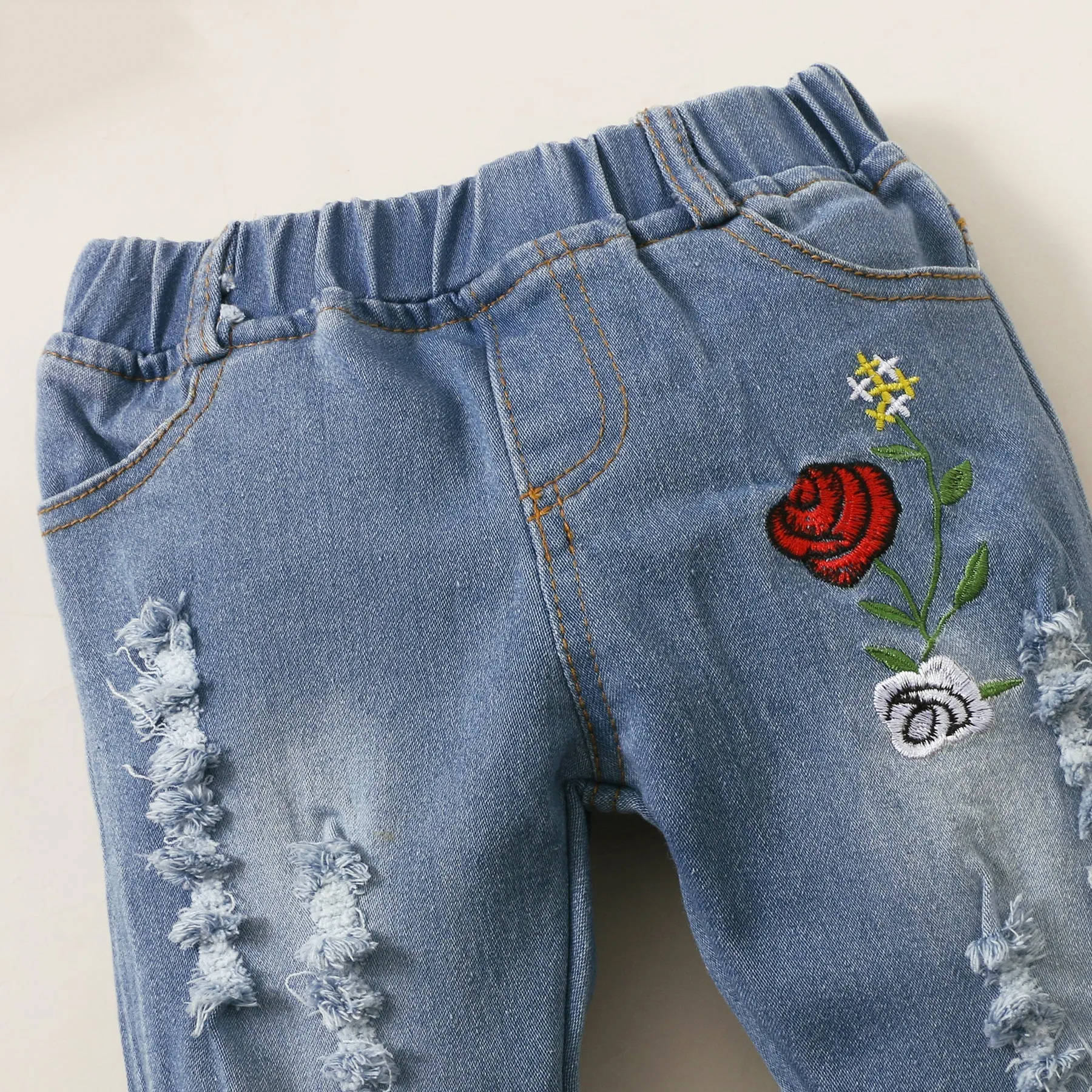 2pcs Baby Red Bell Sleeve Loose-fit Top and Floral Embroidered Ripped Denim Jeans Set